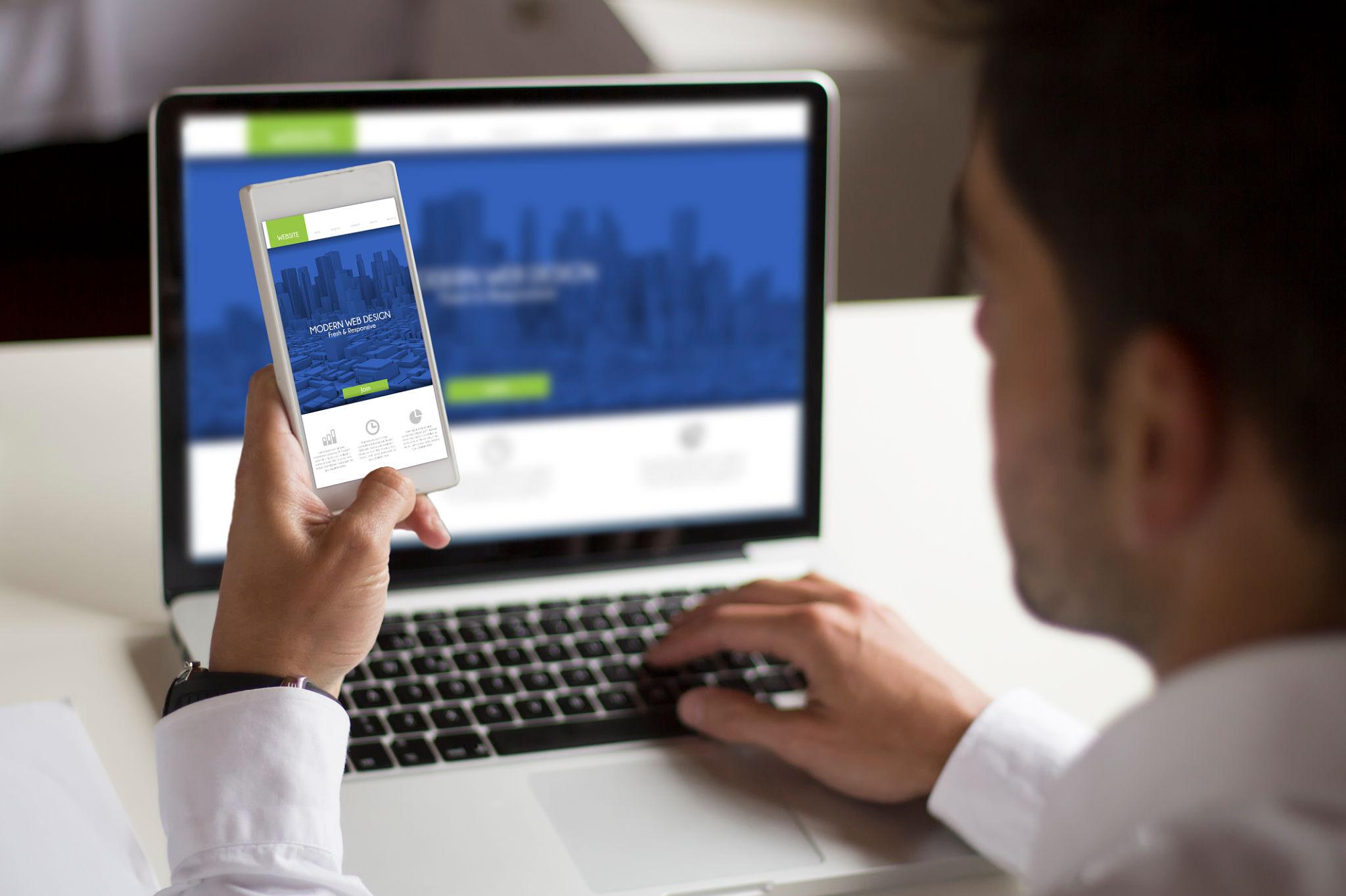 Responsive website design shown on a phone and laptop